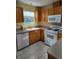 Efficient kitchen with white appliances and bright natural light at 9215 Se 177Th Simons Ln, The Villages, FL 32162