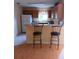 Kitchen with breakfast bar, wood cabinets, and stainless steel appliances at 9215 Se 177Th Simons Ln, The Villages, FL 32162