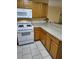 Kitchen boasts wood cabinets and white appliances at 9215 Se 177Th Simons Ln, The Villages, FL 32162