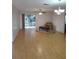 Bright living room with wood floors and sliding glass doors to the patio at 9215 Se 177Th Simons Ln, The Villages, FL 32162