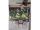 Screened patio has a table with four chairs, tiled flooring, and a view of the backyard at 9215 Se 177Th Simons Ln, The Villages, FL 32162