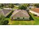 Aerial view of single-Gathering home with landscaped backyard at 5072 Neptune Cir, Oxford, FL 34484