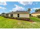 Neatly landscaped backyard with manicured lawn and hedge at 5072 Neptune Cir, Oxford, FL 34484