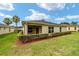 Landscaped backyard with manicured lawn and hedge at 5072 Neptune Cir, Oxford, FL 34484