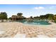 Resort-style pool with a rock waterfall and plenty of lounge chairs at 5072 Neptune Cir, Oxford, FL 34484