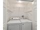 Convenient laundry room with washer, dryer, and ample shelving at 5072 Neptune Cir, Oxford, FL 34484