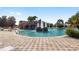 Resort-style pool with waterfall feature and spacious deck at 5072 Neptune Cir, Oxford, FL 34484