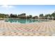 Resort-style pool with waterfall and lounge area at 5072 Neptune Cir, Oxford, FL 34484
