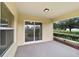 Relaxing screened porch with sliding glass doors and view of backyard at 5072 Neptune Cir, Oxford, FL 34484