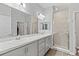 Bright bathroom featuring double sinks, a large mirror, and a walk-in glass shower at 6834 Mossy Oak Ln, Lakeland, FL 33810