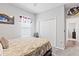 Bedroom with a double door closet, an art piece and a window with blinds at 6834 Mossy Oak Ln, Lakeland, FL 33810