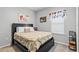 Bedroom with a black bed frame, sneaker artwork, and a large window with blinds at 6834 Mossy Oak Ln, Lakeland, FL 33810