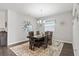 Formal dining room with modern chandelier, designer rug, and large windows that provide lots of natural light at 6834 Mossy Oak Ln, Lakeland, FL 33810