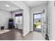 Bright foyer featuring an open floor plan, dark wood laminate floors, and views into the rest of the house at 6834 Mossy Oak Ln, Lakeland, FL 33810