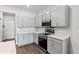 Modern kitchen featuring gray cabinets, stainless steel appliances and dark hard wood flooring at 6834 Mossy Oak Ln, Lakeland, FL 33810