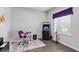 Cozy living room area featuring a large window, stylish decor, and dark wood laminate flooring at 6834 Mossy Oak Ln, Lakeland, FL 33810