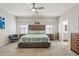 Main bedroom featuring a ceiling fan, a headboard, and carpeted floors at 6834 Mossy Oak Ln, Lakeland, FL 33810