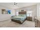 Primary bedroom features a ceiling fan, a large headboard, and carpeted floors at 6834 Mossy Oak Ln, Lakeland, FL 33810