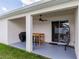 Covered patio includes a ceiling fan, outdoor furniture, and access to the backyard at 6834 Mossy Oak Ln, Lakeland, FL 33810