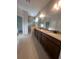 Bathroom featuring double sink vanity, a glass shower, and tile flooring at 2252 Juniper Berry Dr, Minneola, FL 34715