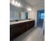 Bathroom featuring a double sink vanity with gray tile floor at 2252 Juniper Berry Dr, Minneola, FL 34715