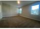 Bedroom featuring carpeted floors and two windows offering ample natural light at 2252 Juniper Berry Dr, Minneola, FL 34715