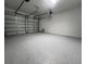 Spacious garage with epoxy floors and two garage doors providing ample storage at 2252 Juniper Berry Dr, Minneola, FL 34715