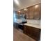 Updated kitchen with stainless steel appliances, white countertops, and dark wood cabinets at 2252 Juniper Berry Dr, Minneola, FL 34715