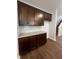 Kitchen boasts dark cabinets, white quartz countertops and subway tile backsplash at 2252 Juniper Berry Dr, Minneola, FL 34715