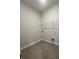 Neutral laundry room with tile floors and white wire shelving at 2252 Juniper Berry Dr, Minneola, FL 34715