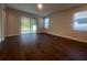 Spacious living room with wood floors and sliding doors with access to the backyard at 2252 Juniper Berry Dr, Minneola, FL 34715