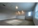 Cozy loft space with carpet, neutral colors, and natural light from the window at 2252 Juniper Berry Dr, Minneola, FL 34715