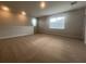 A spacious loft area with neutral carpet and lots of natural light from two windows at 2252 Juniper Berry Dr, Minneola, FL 34715