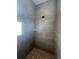 A modern tiled shower with glass shelving and stone flooring at 2252 Juniper Berry Dr, Minneola, FL 34715