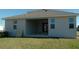Exterior view of back of house featuring covered patio and grassy yard at 2311 Juniper Berry Dr, Minneola, FL 34715