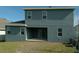 The home's exterior is painted blue-gray and offers a covered patio and grassy area at 2311 Juniper Berry Dr, Minneola, FL 34715