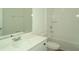 Well-lit bathroom featuring modern fixtures, a spacious vanity, and a bathtub with tiled surround at 2311 Juniper Berry Dr, Minneola, FL 34715