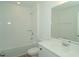 Well-lit bathroom features a tub and shower combination and large mirror over vanity at 2311 Juniper Berry Dr, Minneola, FL 34715