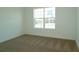 Bedroom features new carpet, a window with natural light, and neutral decor at 2311 Juniper Berry Dr, Minneola, FL 34715