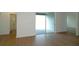 Spacious bedroom with new flooring, sliding glass doors to lanai, and access to bathroom at 2311 Juniper Berry Dr, Minneola, FL 34715