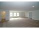 Expansive carpeted bonus room with natural light, versatile for entertainment, play, or relaxation at 2311 Juniper Berry Dr, Minneola, FL 34715