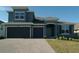 Charming two-story home featuring a two-car garage, well-manicured lawn, and brick-paved driveway at 2311 Juniper Berry Dr, Minneola, FL 34715