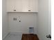 A laundry room equipped with white cabinets ready for your appliances to be installed at 2311 Juniper Berry Dr, Minneola, FL 34715