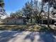 Two houses on a lot with mature trees and a street at 1010 S Grove St, Eustis, FL 32726