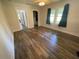 Bedroom with modern wood-look vinyl flooring, ceiling fan and neutral paint at 1010 S Grove St, Eustis, FL 32726