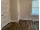 Cozy bedroom with wood floors, bright window, and two white painted closets at 1010 S Grove St, Eustis, FL 32726