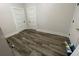 Bedroom with modern wood-look vinyl flooring and painted white doors at 1010 S Grove St, Eustis, FL 32726