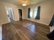 Bedroom with modern wood-look vinyl flooring, ceiling fan and neutral paint at 1010 S Grove St, Eustis, FL 32726