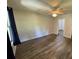 Bedroom with modern wood-look vinyl flooring, ceiling fan and neutral paint at 1010 S Grove St, Eustis, FL 32726