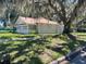 Well-maintained home with mature trees, offering a serene and inviting atmosphere at 1010 S Grove St, Eustis, FL 32726